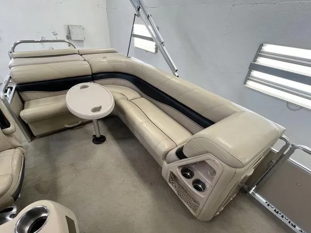 Slide: The Image of 2007 Harris Classic 240 I/O boat interior with beige seating and small table. - 10