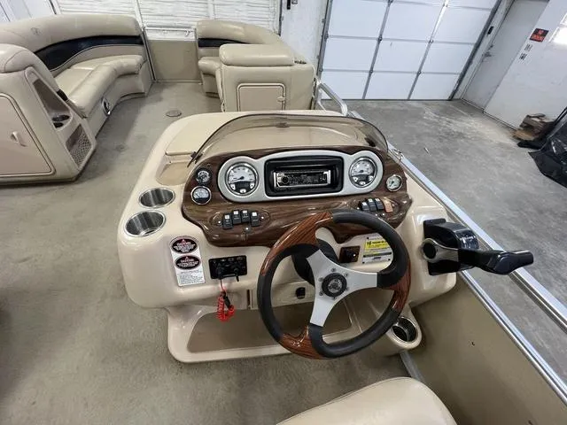 Slide: The Image of 2007 Harris Classic 240 I/O boat interior with steering wheel and dashboard controls. - 13