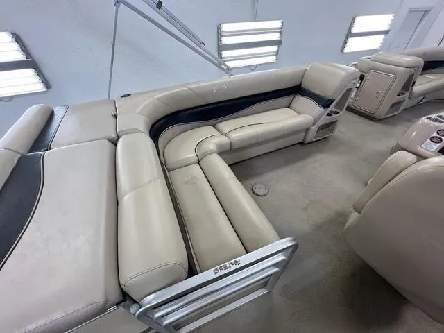 Slide: The Image of 2007 Harris Classic 240 I/O boat interior with beige seating and modern design. - 15