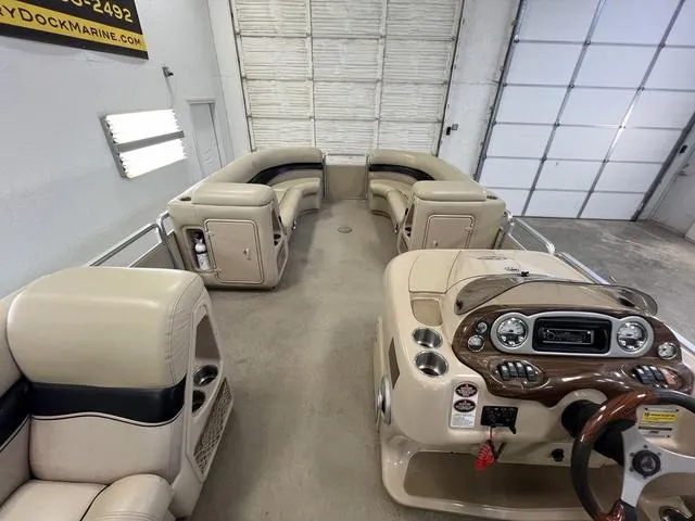 Slide: The Image of 2007 Harris Classic 240 I/O boat interior with beige seating and control panel. - 16