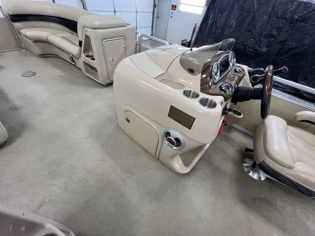Slide: The Image of 2007 Harris Classic 240 I/O boat interior with beige seating and steering console. - 17
