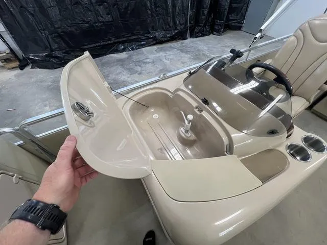 Slide: The Image of 2007 Harris Classic 240 I/O boat console with storage compartment and steering wheel. - 18