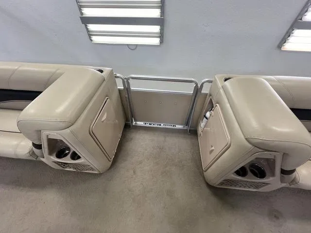 Slide: The Image of Interior of 2007 Harris Classic 240 I/O boat with beige seating and cup holders. - 23