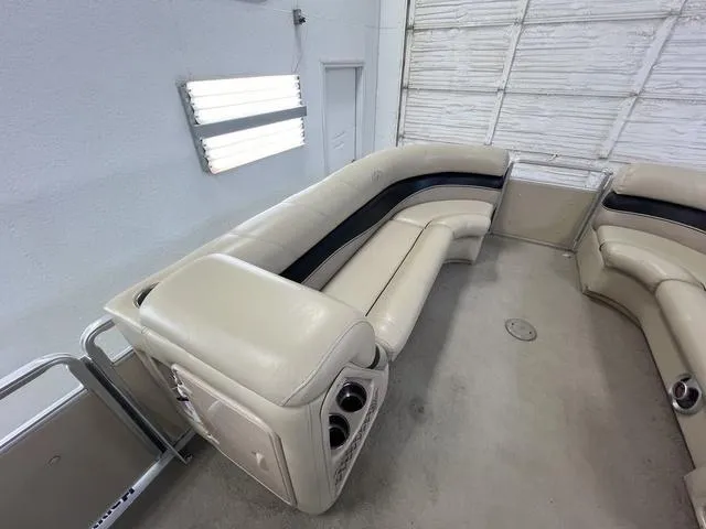 Slide: The Image of 2007 Harris Classic 240 I/O boat interior with beige seating and cup holders. - 25