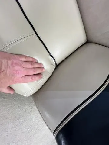 Slide: The Image of Close-up of a 2007 Harris Classic 240 I/O boat seat with hand touching upholstery. - 28