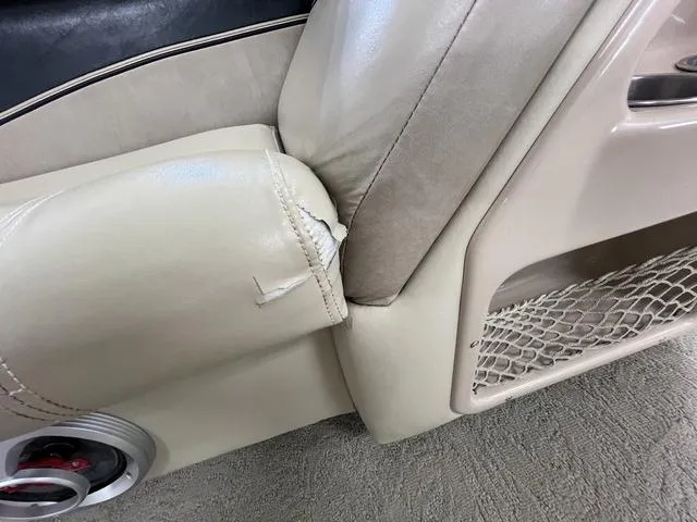 Slide: The Image of Torn upholstery on 2007 Harris Classic 240 I/O boat seat, beige interior detail. - 29