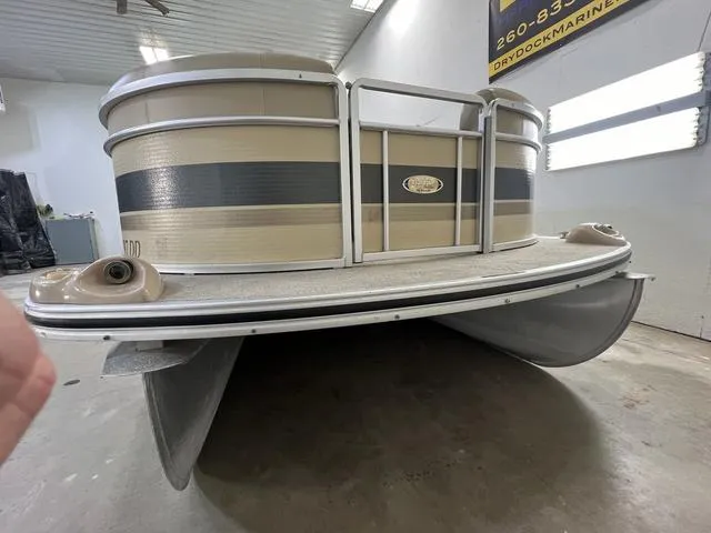 Slide: The Image of 2007 Harris Classic 240 I/O pontoon boat in a garage setting. - 3