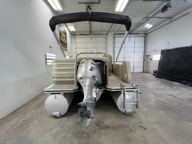 Slide: The Image of 2007 Harris Classic 240 I/O pontoon boat in a garage, rear view. - 6