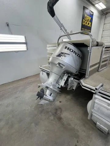 Slide: The Image of 2007 Harris Classic 240 I/O boat with Honda outboard motor in a garage. - 7