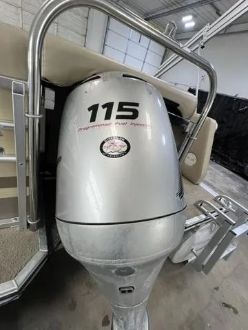 Slide: The Image of 2007 Harris Classic 240 I/O boat with 115 horsepower engine in a garage setting. - 8