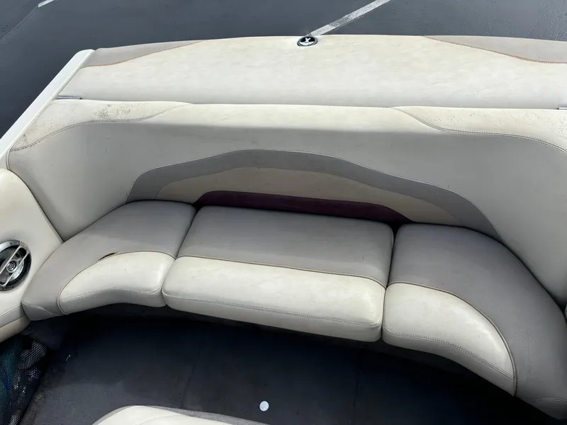 Slide: The Image of 2007 Malibu iRide boat interior seating with beige and gray upholstery. - 2