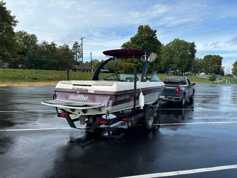 Slide: The Image of 2007 Malibu iRide boat on trailer in parking lot, overcast day. - 4
