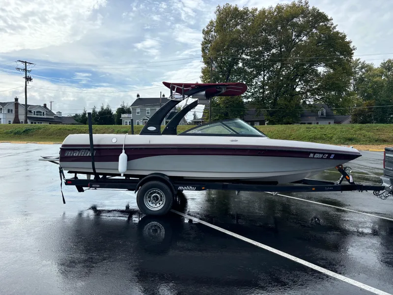 Slide: The Image of 2007 Malibu iRide boat on trailer in parking lot, overcast sky. - 5