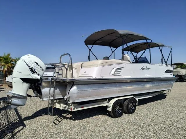 Slide: The Image of 2018 Avalon Excalibur Quad Lounge Windshield 27' pontoon boat interior with plush seating. - 10