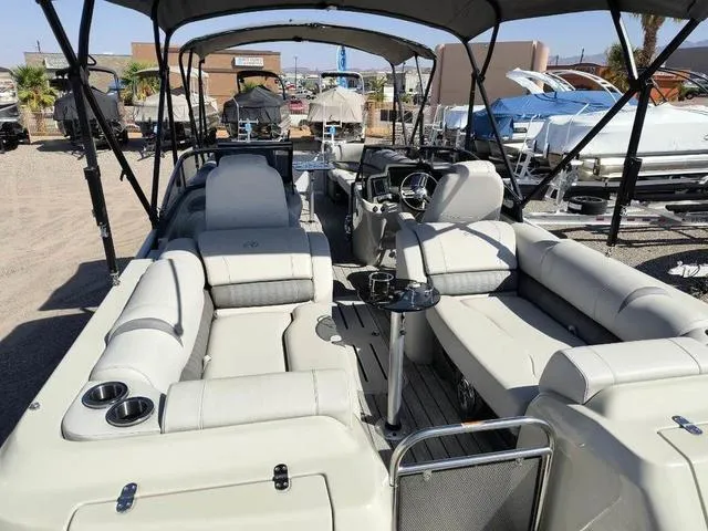 Slide: The Image of 2018 Avalon Excalibur Quad Lounge Windshield 27' boat interior with spacious seating. - 11