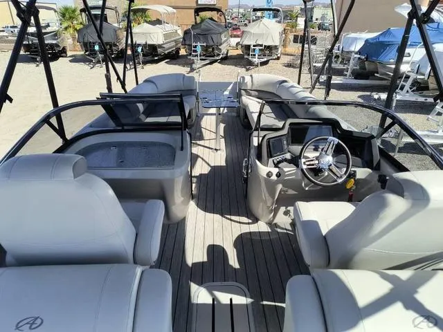 Slide: The Image of 2018 Avalon Excalibur Quad Lounge Windshield 27' boat interior with seating and canopy. - 12