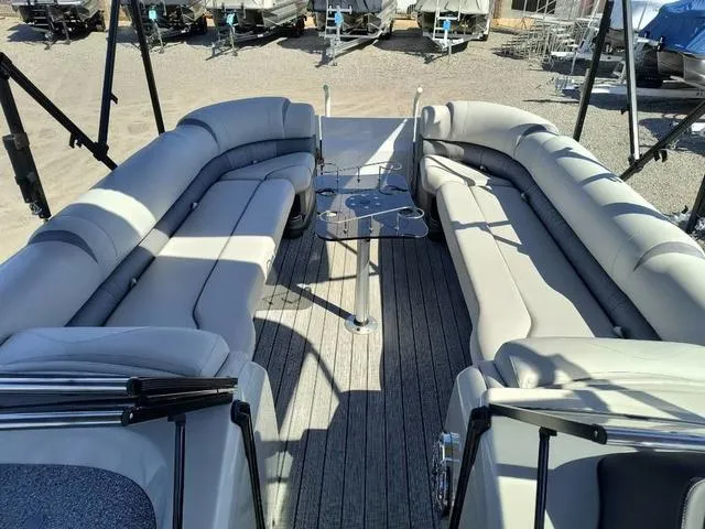 Slide: The Image of 2018 Avalon Excalibur Quad Lounge boat with windshield, docked in a marina. - 15