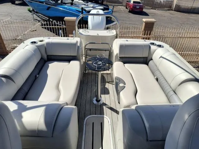 Slide: The Image of 2018 Avalon Excalibur Quad Lounge Windshield 27' boat with spacious seating and sleek design. - 19