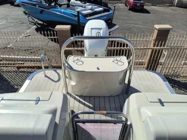 Slide: The Image of 2018 Avalon Excalibur Quad Lounge Windshield 27' boat, rear view with seating and motor. - 20