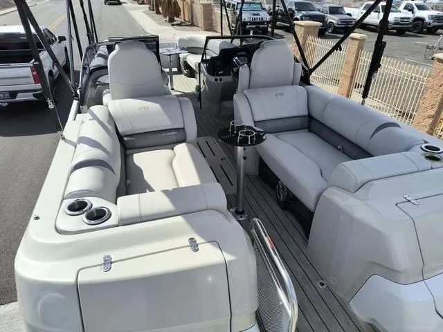 Slide: The Image of 2018 Avalon Excalibur Quad Lounge Windshield 27' pontoon boat with luxurious seating and cup holders. - 24