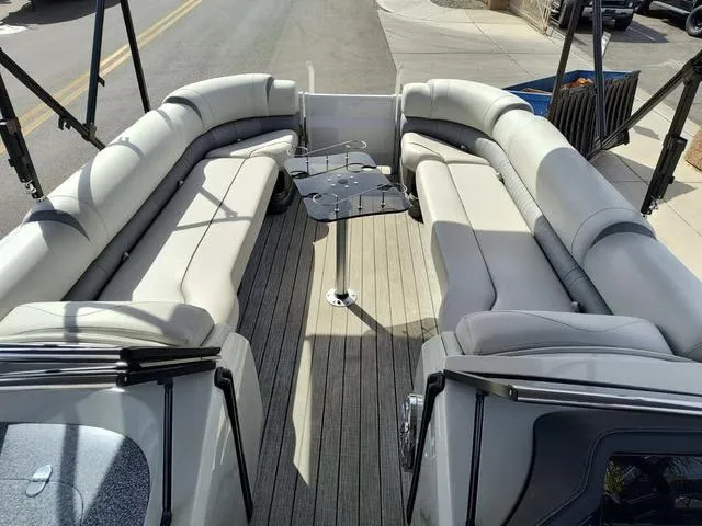 Slide: The Image of 2018 Avalon Excalibur Quad Lounge Windshield 27' boat with spacious seating and sleek design. - 26