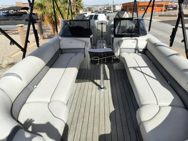 Slide: The Image of 2018 Avalon Excalibur Quad Lounge Windshield 27' boat with spacious seating and modern design. - 27