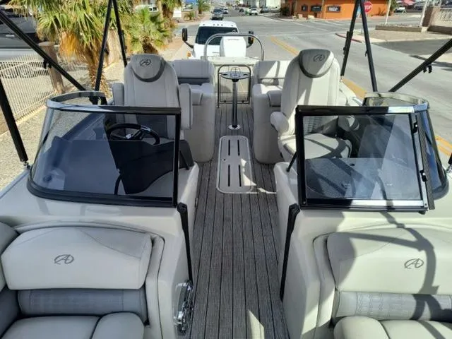 Slide: The Image of 2018 Avalon Excalibur Quad Lounge Windshield 27' boat interior with plush seating and dual windshields. - 28