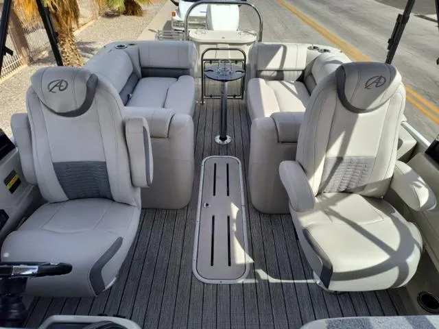 Slide: The Image of 2018 Avalon Excalibur Quad Lounge Windshield 27' interior with luxurious seating and modern design. - 29