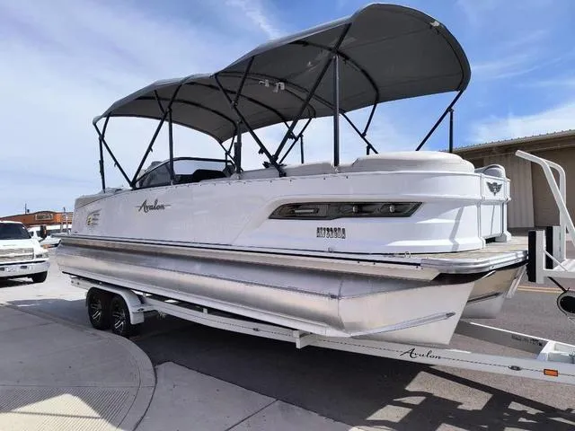 Slide: The Image of 2018 Avalon Excalibur Quad Lounge Windshield 27' pontoon boat on trailer. - 3