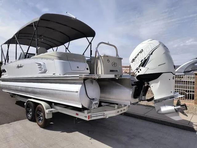 Slide: The Image of 2018 Avalon Excalibur Quad Lounge Windshield 27' pontoon boat on trailer, sunny day. - 4