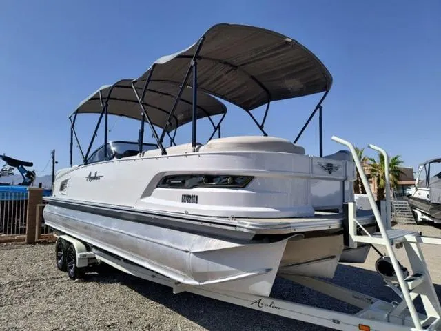 Slide: The Image of 2018 Avalon Excalibur Quad Lounge Windshield 27' pontoon boat with spacious seating and canopy. - 6