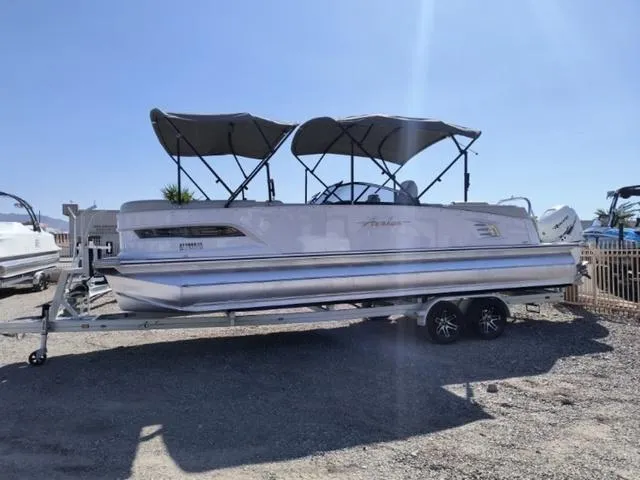 Slide: The Image of 2018 Avalon Excalibur Quad Lounge Windshield 27' boat interior with seating and steering console. - 7