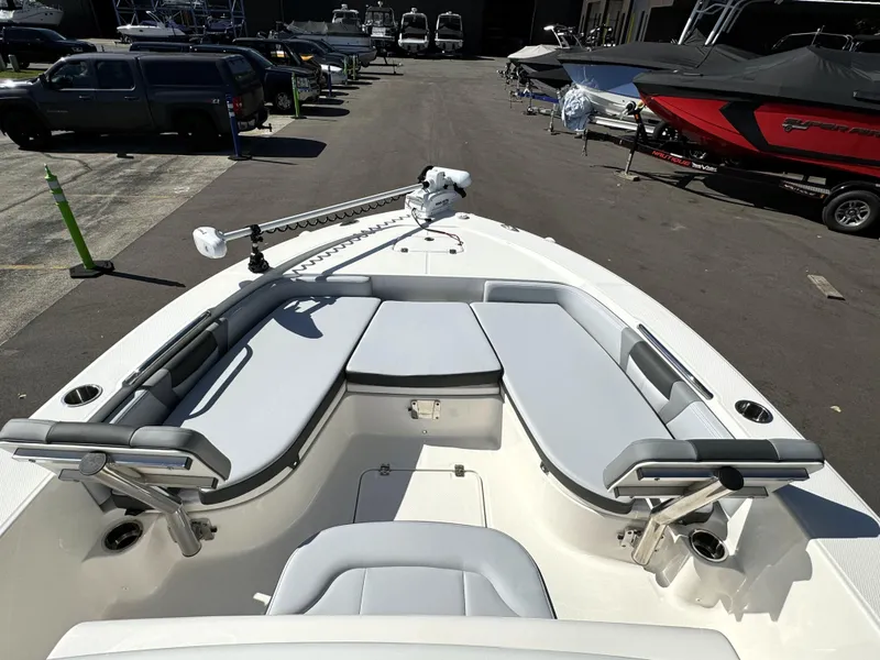 Slide: The Image of 2025 Robalo 226 Cayman boat with spacious seating and modern design in a marina setting. - 12