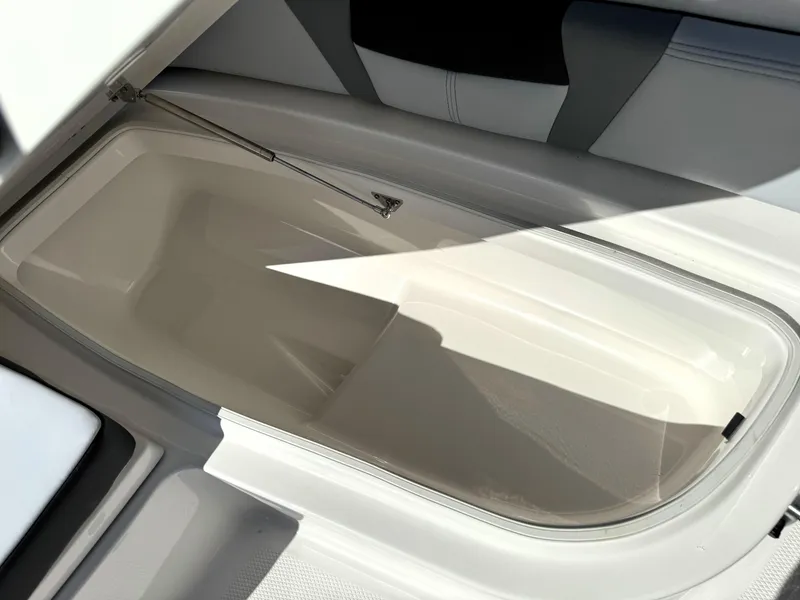 Slide: The Image of Storage compartment of 2025 Robalo 226 Cayman boat, open and empty. - 17
