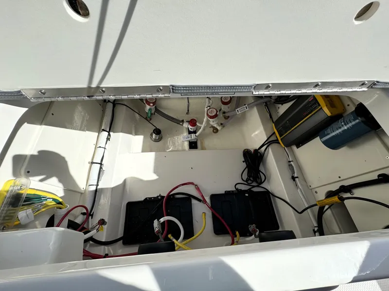 Slide: The Image of 2025 Robalo 226 Cayman boat interior showing battery and wiring setup. - 22