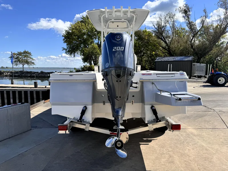 Slide: The Image of 2025 Robalo 226 Cayman boat with powerful 200 HP engine, docked near a scenic waterfront. - 3