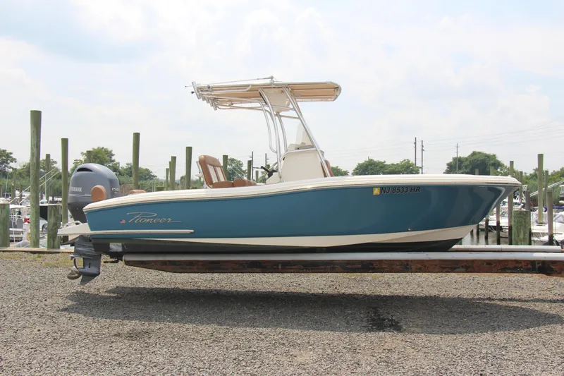 Slide: The Image of 2022 Pioneer 202 Sportfish boat on display at a marina. - 0