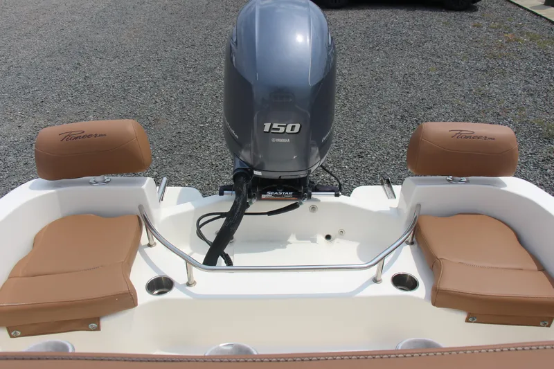Slide: The Image of 2022 Pioneer 202 Sportfish boat with Yamaha 150 engine and tan seating. - 11