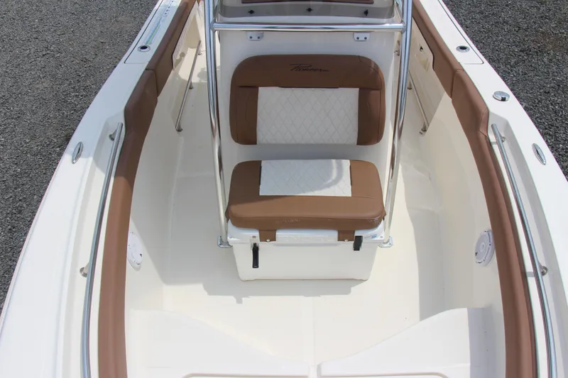Slide: The Image of 2022 Pioneer 202 Sportfish boat interior with brown and white seating. - 13
