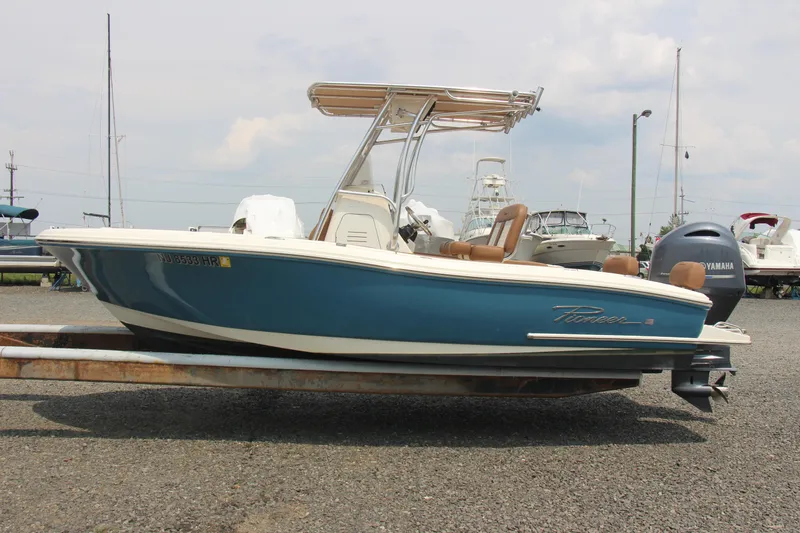 Slide: The Image of 2022 Pioneer 202 Sportfish boat with Yamaha outboard, parked on gravel. - 4