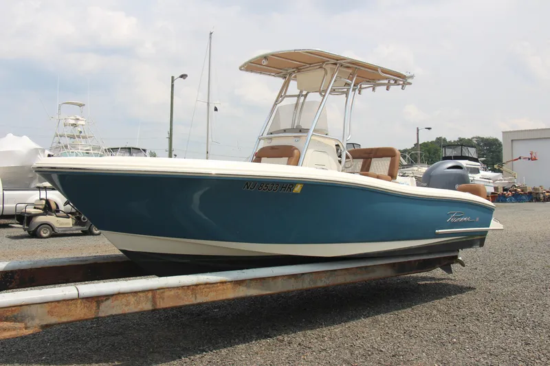 Slide: The Image of 2022 Pioneer 202 Sportfish boat on trailer, blue hull, outdoor setting. - 5