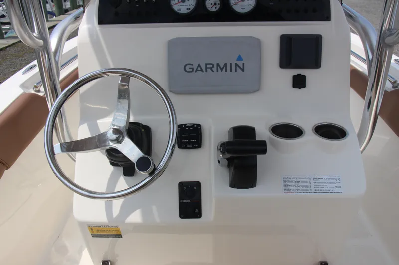 Slide: The Image of Pioneer 202 Sportfish 2022 boat console with Garmin navigation and steering wheel. - 7