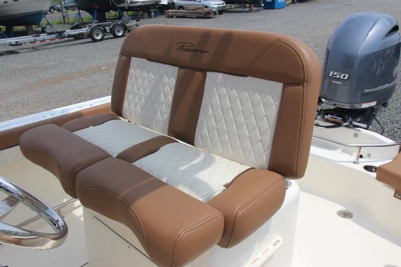 Slide: The Image of 2022 Pioneer 202 Sportfish boat with brown and white cushioned seating and Yamaha 150 outboard motor. - 9