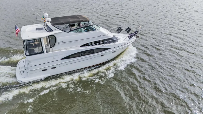 Slide: The Image of 2004 Carver 466 Motor Yacht cruising on open water. - 0