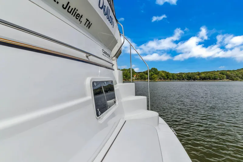 Slide: The Image of 2004 Carver 466 Motor Yacht on serene lake with blue sky. - 10