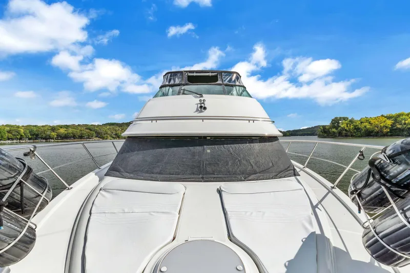 Slide: The Image of 2004 Carver 466 Motor Yacht on a scenic river under blue skies. - 11