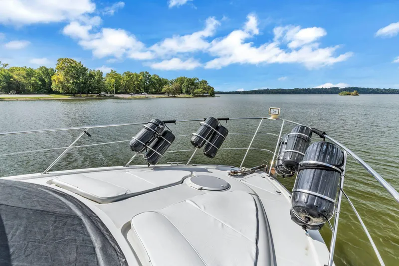 Slide: The Image of 2004 Carver 466 Motor Yacht on serene lake with clear blue sky. - 12
