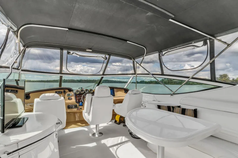 Slide: The Image of Interior of 2004 Carver 466 Motor Yacht with modern seating and panoramic windows. - 13