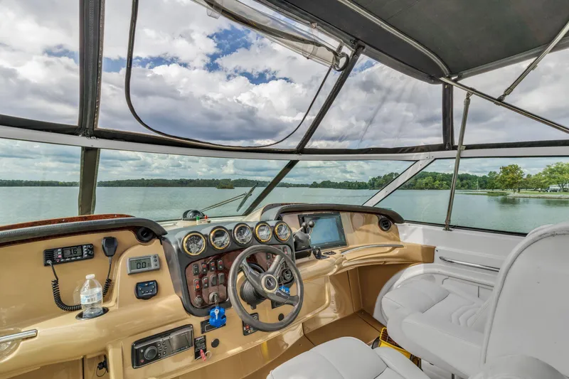 Slide: The Image of Interior view of 2004 Carver 466 Motor Yacht helm with lake backdrop. - 15