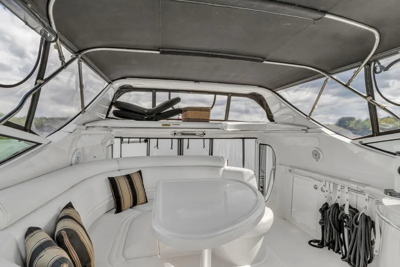Slide: The Image of Interior of 2004 Carver 466 Motor Yacht with white seating and table. - 16